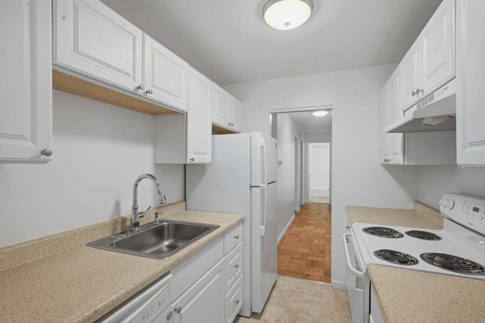 Galley kitchen with sink, dishwasher and refrigerator