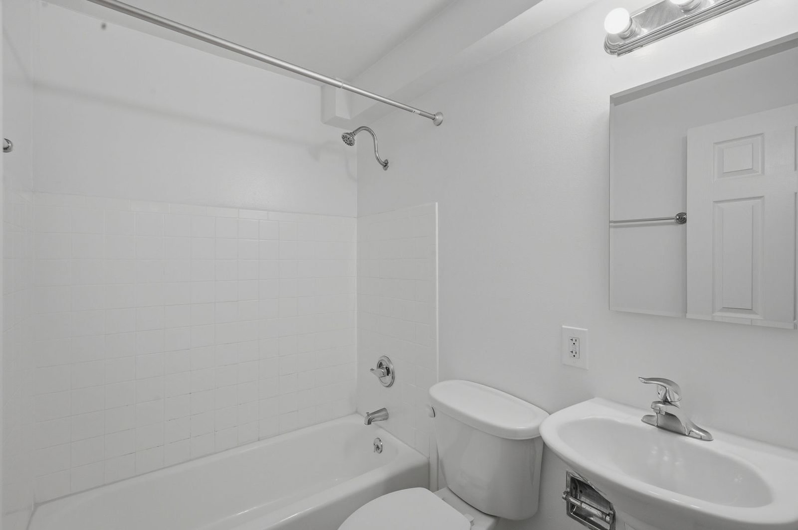 Bathroom with pedestal sink and tub